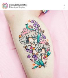 a woman's thigh with mushrooms and flowers on it