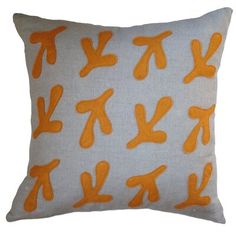 an orange and white pillow with the letter k on it