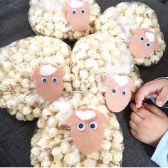 a person holding a cell phone in front of a stuffed animal with eyes and nose