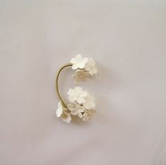 Delicate Single Cartilage Earring, White Single Ear Climber For Wedding, Elegant White Cartilage Earrings Gift, White Single Ear Cuff As Gift, Dainty Spring Wedding Flower Earrings, Dainty Flower Earrings For Spring Wedding, Dainty Spring Flower Earrings For Wedding, Single White Flower Earring For Wedding, Delicate White Flower Earrings