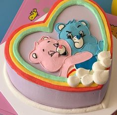 there is a heart shaped cake with two bears on it