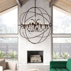 a living room filled with furniture and a large chandelier hanging from the ceiling