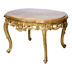 an ornate gold coffee table with marble top