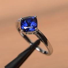 a blue ring sitting on top of a wooden table