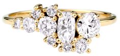 a yellow gold ring with three pear shaped diamonds