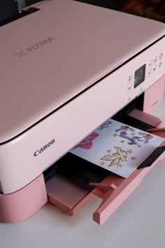 a pink printer sitting on top of a table