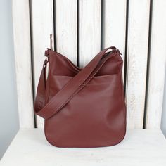 "If you value sophisticated accessories and you're looking for a multifunctional bag in gorgeous color, you are in a good place. This simple burgundy hobo purse looks great as shoulder or crossbody tote. Fits really well with any womens casual outfit. Made of high quality vegan leather. One of the bags perfect for everyday use - for work, shopping or little talks with your best friend. Easy to pack, large enough for all your items on the go. Cotton lining with three pockets, one of them fastened Leather Work Bag, Vegan Purses, Hobo Crossbody Bag, Hobo Purse, Gift For Best Friend, Large Shoulder Bags, Work Bag, Crossbody Tote, Womens Casual