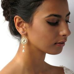 "I created this Pearl wedding earring by hand, using Swarovski Rivoli 10mm for each one, Swarovski 3-5 mm pearls, Swarovski drop pearl, Miyuki round seed beads, Miyuki Delica beads, and 14k goldfilled ear-wire Elegant, feminine and impressive * Measurements: Earring length: 2.36\" (6cm) Pendant diameter: 0.78\" (2cm) * The earrings will come beautifully packaged for a gift. * For other Bridal earrings: https://www.etsy.com/ca/shop/LioraBJewelry?ref=listing-shop2-all-items-count%C2%A7ion_id&s Pearl Dangle Crystal Earrings For Wedding, Wedding Pearl Drop Crystal Earrings, Gold Pearl Crystal Earrings For Wedding, Delicate Round Bridal Earrings For Wedding, Delicate Bridal Earrings For Wedding, Pearl White Crystal Drop Earrings For Wedding, Pearl White Chandelier Earrings With Pearl Drop For Wedding, Wedding Pearl White Chandelier Earrings With Pearl Drop, Pearl Dangle Earrings For Wedding