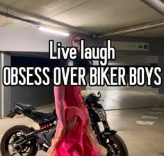 a woman in a pink dress standing next to a black and white motorcycle with the words i live laugh obses over biker boys