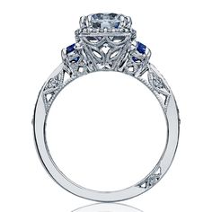 a diamond and blue sapphire engagement ring with an intricate design on the side, set in 18k white gold