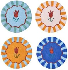 four circular rugs with flowers on them in different colors and designs, each featuring an individual's own flower