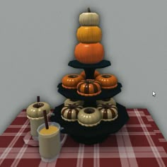 a table topped with cakes and pumpkins on top of a checkered table cloth