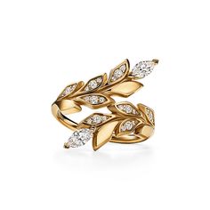 Inspired by the natural world, Tiffany Victoria designs capture the fluid movement of flowers, vines and leaves with a mix of expertly cut diamonds. This bypass ring is crafted of 18k gold that features a contrast of high polish and sandblasted finishes. Round brilliant and marquise diamonds play off the light and accentuate the vine motif. When too many diamonds are never enough, Tiffany Victoria is the ultimate way to shine. Wear it solo for maximum impact. 18k yellow gold with round brilliant Tiffany Victoria, Tiffany Rings, Online Gold Jewellery, High Jewelry Ring, International Jewelry, Bypass Ring, Gold Rings Fashion, Tiffany Jewelry, Turkish Jewelry