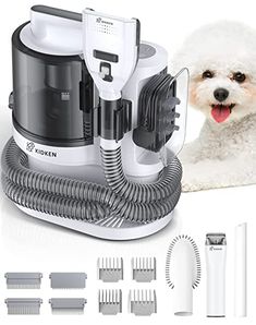 a white dog laying down next to a vacuum and hairdryer with its mouth open