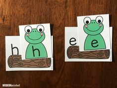 two cards with the letters h and e on them, one has a frog sitting on a log