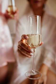 a woman holding a wine glass with the word jane written on it in cursive writing