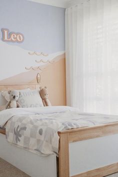 a child's bedroom with a teddy bear on the bed