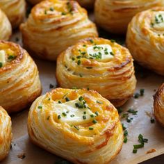 there are many rolls with cheese and chives on the top one is cheesy