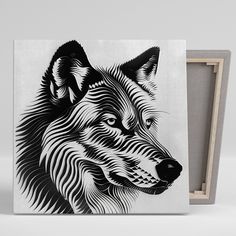 a black and white drawing of a wolf's head on a canvas next to a wooden frame