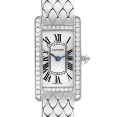 Cartier Tank Americaine White Gold Diamond Ladies Watch WB710009. Quartz movement. 18K white gold case 19.0 x 35.0 mm. Octagonal crown set with an original Cartier factory faceted diamond. 18k white gold original Cartier factory diamond bezel. Scratch resistant sapphire crystal. Silvered grained dial with black Roman numerals. Sword shaped blued steel hands. 18K white gold bracelet with hidden butterfly clasp. Fits 6.5" wrist. Cartier Jewelry With Diamond Hour Markers, Cartier Luxury Diamond Watch For Wedding, Cartier Diamond Watch For Wedding, Elegant Cartier Watches For Wedding, Cartier White Gold Diamond Watch With Round Dial, Elegant Cartier Diamond Watch For Wedding, Timeless Cartier Diamond Watch In Platinum, Cartier Diamond Watch For Formal Occasions, Formal Cartier Diamond Watch With Accents