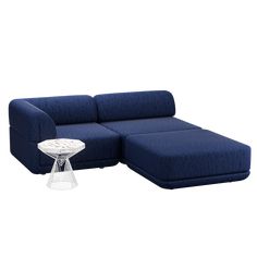 a blue couch with a white table on the bottom and one arm folded out to form a corner