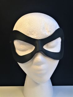 DESCRIPTIONAdd spice to your love life! This small, very lightweight, black leather mask is perfect for the beginner dominatrix or Lord of the Bedroom. Any color. Silver studs available. Waterproofed leather, glossy or matte finish, & several choices to affix the mask (cord, elastic, ribbon, waterproof cord, stick, or no holes for adhesive). Measurements: 3" high x 7" wide (tallest & widest points); 1" high between the eyes; 2.75" wide x 2.75" tall eye openings ---------------------------------- Lone Ranger Costume, Splatoon Costume, Mask Cord, Robin Superhero, Comicon Costume, Wedding Masquerade, Ranger Costume, New Years Eve Ball, Robin Cosplay