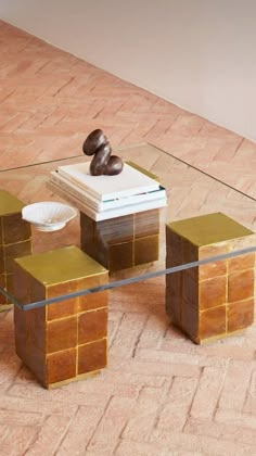 a glass table with some books on top of it and a book in the middle