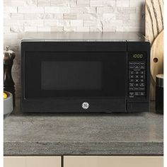 a black microwave oven sitting on top of a counter