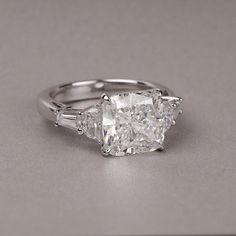 three stone engagement ring with baguetts on the sides