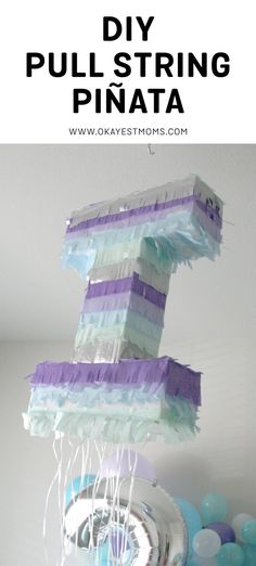 the number one is made out of tissue paper and some balloons are in front of it