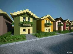 a row of colorful houses sitting next to each other on a city street in minecraft