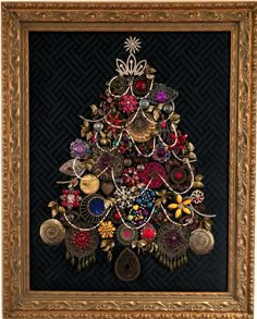 a christmas tree made out of buttons and other items in a gold framed frame on a black background