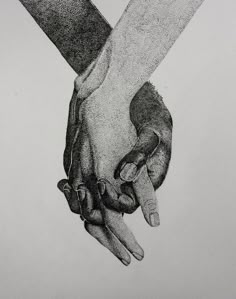 two hands holding each other over a piece of paper that has writing on it and is black and white