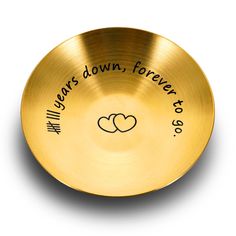 a gold plate with two hearts on it that says years down, forever to go