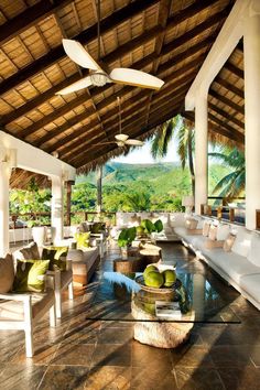 an outdoor living area with couches and tables