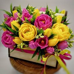 a bouquet of flowers sitting on top of a wooden box