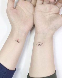 two small wrist tattoos on both hands