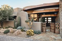 a house with cactus and cacti in front of it