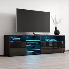 an entertainment center with a flat screen tv mounted on it's side