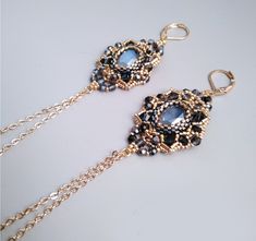 Bright grey-black chandelier earrings, plated with pure 24 carat gold, with an elegant assembly of  cabocon and beads, Swarovski crystals, chain (5 cm). Length: earrings with ear hooks and chain -10 cm. These modern earrings will be a great addition to your festive outfit. In my boutique you will find similar earrings in other colors. You can also choose a jewelry set in the same color (necklace, bracelet and ring). Write to me if you need a specific model of jewelry. I will try to help you. Created by the KaliaZ team Elegant Gold Beaded Chain Chandelier Earrings, Elegant Gold Chandelier Earrings With Beaded Chain, Elegant Beaded Chandelier Earrings, Elegant Beaded Chain Earrings, Bracelet And Ring, Crystal Chandelier Earrings, 24 Karat Gold, Color Necklace, Black Chandelier