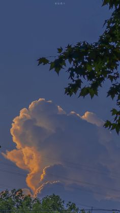 the sky is filled with clouds as the sun sets in the distance behind some trees