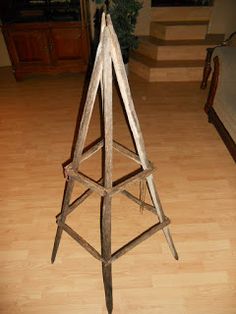 a tall wooden stool sitting on top of a hard wood floor