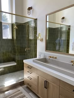 a bathroom with two sinks and a large mirror