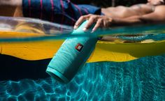 a man laying on top of a yellow surfboard under water