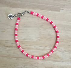 "Add that extra pop to any outfit this summer with this bright coral pink anklet! The anklet is made with an array of coral pink colored polymer beads and finished with a charm of your choice! Colors may vary from image. The anklet is available in a variety of sizes, just message me for custom sizes or an adjusted extender length! There is a size for everyone! :)  * All anklet sizes selected from the drop down menu are the size of the anklet without the 1/4\" chain extender. When selecting a siz Cheap Pink Anklets For Festivals, Cheap Pink Round Beads Anklets, Pink Heishi Beads Friendship Bracelets For Beach, Pink Heishi Beads Friendship Bracelets For Vacation, Handmade Coral Bracelets For Summer, Adjustable Coral Beaded Bracelets For Summer, Adjustable Pink Anklet With Colorful Beads, Casual Pink Handmade Anklet, Pink Heishi Beads Vacation Bracelets