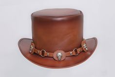 Description: * High-Quality Craftsmanship hand made * Real Leather * 100% pure leather **Those living in remote areas will have to pay $50 extra as shipping charges before the item is shipped. Sizing Heads come in all sizes, and in a lots variety of shapes. Although high quality hats are adaptable, and will usually conform to differences in shape with a little wearing, it is essential that the size be correct for the head. To determine your hat size, measure the circumference around your head, k Brown Leather Hats For Festivals, Custom Handmade Brown Top Hat, Custom Brown Top Hat For Festival, Steampunk Leather Brimmed Hat Bands, Steampunk Leather Top Hat With Flat Crown, Vintage Leather Hat With High Crown, Vintage High Crown Leather Hat, Vintage Leather High Crown Hat, Handmade Brown Top Hat For Western-themed Events