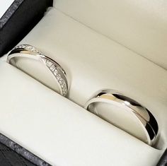 two wedding rings sitting in a box together