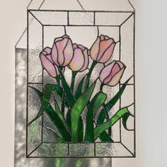 a stained glass window with pink flowers in it