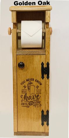 a toilet paper dispenser made out of wood with the words golden oak written on it