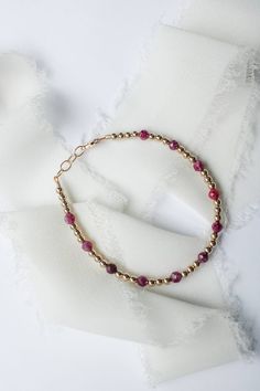 This July birthstone bracelet is crafted with genuine ruby gems, making it a perfect gift or a special treat for yourself. Stylish and elegant, the bracelet is sure to add a touch of sparkle to any outfit.  Rubys are said to promote healing and recovery. Made to last with 14k gold filled hardware. Comes in baby though adult sizes. Check out our size guide for help with sizing. We look forward to seeing you and your sweet little ones wearing your bracelets #joyfulbead. * Due to the nature of our Pink Ruby Bracelets With Gemstone, Pink Ruby Bracelets As Gift, Pink Ruby Round Bracelets, Handmade Adjustable Ruby Bracelets, Handmade Ruby Bangle Bracelet, Handmade Adjustable Ruby Bracelet, Round Bead Birthstone Bracelets For Gifts, Round Beads Birthstone Bracelets For Gifts, Birthstone Bracelets With Round Beads For Gifts